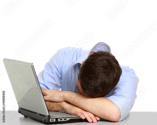 Photo: young business man sleeping on the laptop young business man sleeping on the laptop