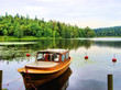 Photo: Tranquil Finnish landscape: single boat in a calm lake Tranquil Finnish landscape: single boat in a calm lake