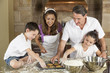 Attractive Family Baking and Eating Cookies In A Kitchen