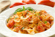 Farfalle topped with tomato sauce, tuna and basil