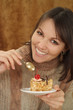 Beautiful Caucasian woman sitting at a table with a cake
