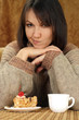 Pretty Caucasian woman sitting at a table with a cake