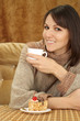 Pretty Caucasian woman sitting at a table with a cake