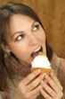 Nice Caucasian woman sitting at a table with a cake