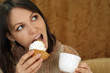 Nice Caucasian woman sitting at a table with a cake