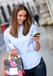 Shopping woman sending a text