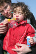 delightful toddler with daddy making soap bubbles