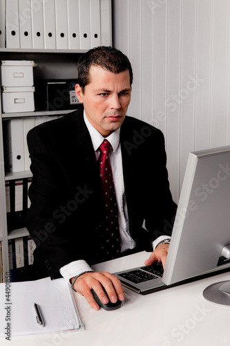 Photo: Geschäftsmann im Büro mit Computer Geschäftsmann im Büro mit Computer