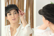 Woman trying on a cap