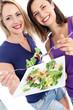 Two attractive women enjoying a healthy salad