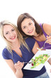 Photo: Two pretty women friends enjoying a healthy salad Two pretty women friends enjoying a healthy salad