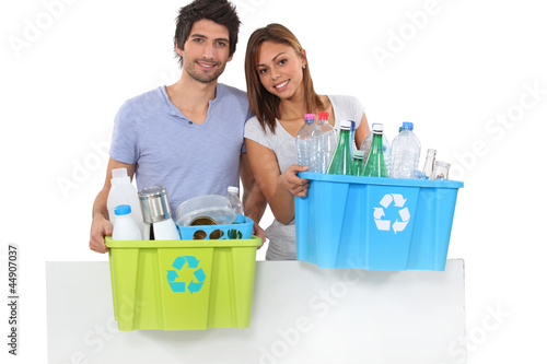 Photo: Couple recycling plastic bottles Couple recycling plastic bottles