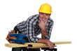 Carpenter casually leaning on work bench