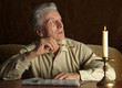 Beautiful Caucasian old man sitting at a table