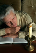 Beautiful happy Caucasian elderly man sitting at a table
