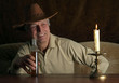 Beautiful elderly man sitting at a table