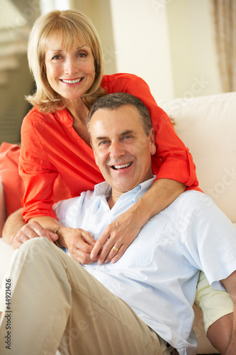 Photo: Senior Couple Relaxing On Sofa At Home Senior Couple Relaxing On Sofa At Home
