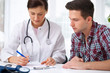 Ärztin berät einen jungen Patienten