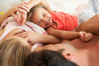 Photo: Family Relaxing Together In Bed Family Relaxing Together In Bed