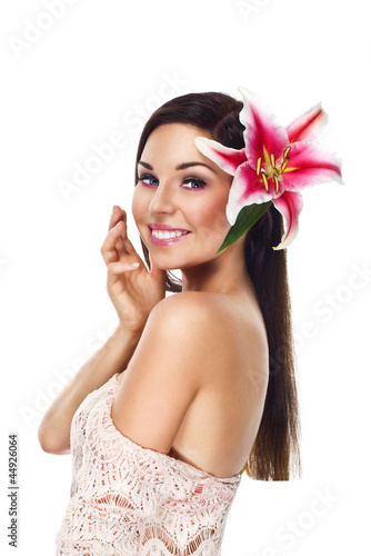 Photo: beautiful woman portrait with long healthy hair and lilly flower beautiful woman portrait with long healthy hair and lilly flower
