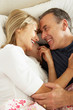 Photo: Senior Couple Relaxing Together In Bed Senior Couple Relaxing Together In Bed