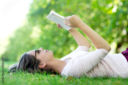 Photo: Summer woman reading outdoors Summer woman reading outdoors