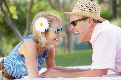 Photo: Senior Couple Relaxing In Summer Garden Senior Couple Relaxing In Summer Garden