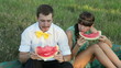 Young couple eating watermelon at picnic