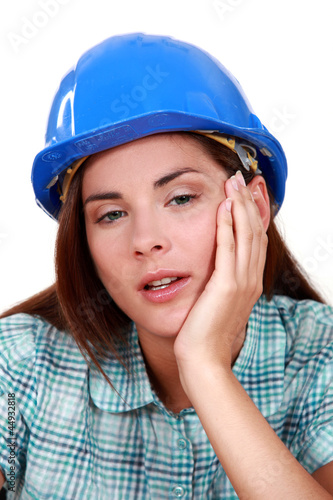 Photo: A tired-looking tradeswoman A tired-looking tradeswoman