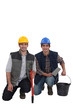 Two smiling construction workers