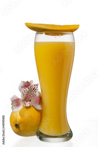 Photo: mango juice glass with slice of mango on top mango juice glass with slice of mango on top