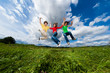 Active family - mother and kids running, jumping outdoor