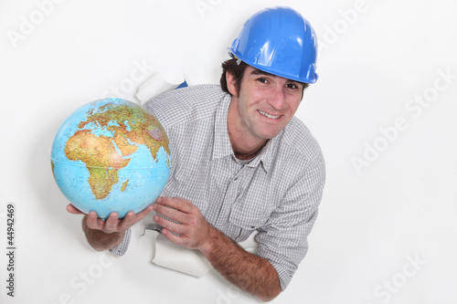 Photo: Tradesman holding a globe Tradesman holding a globe