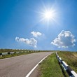 asphalt road under a sparkle sun