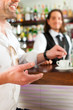 Barista with client in his cafe or coffeeshop