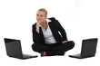 woman sitting on the floor with two laptops