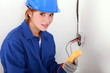 Woman using a multimeter