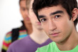 Young man standing beside his friends