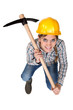 A female construction worker with a pickaxe.