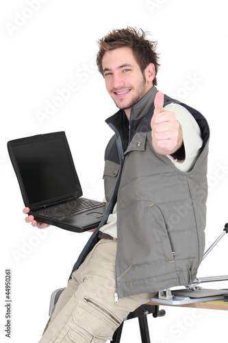 Photo: Tiler with a laptop Tiler with a laptop