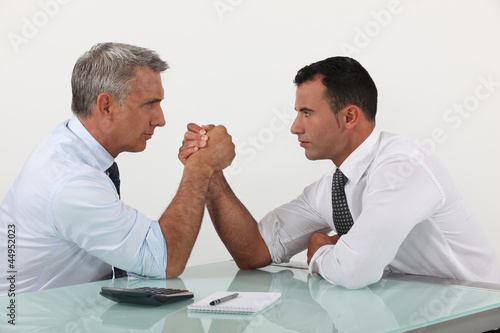 Photo: Businessmen arm wrestling Businessmen arm wrestling