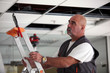 Man moving a ladder