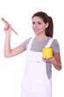 Woman holding paint tin and brush