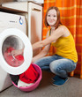 Woman loading the washing machine