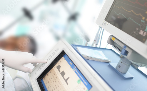 Photo: In the ICU. Doctor changes the parameters artificial lung ventil In the ICU. Doctor changes the parameters artificial lung ventil