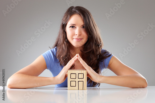 Photo: Young proudly woman make a roof with hands, symbolical Young proudly woman make a roof with hands, symbolical
