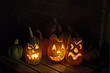 Squashes and carved eggplant lanterns at halloween