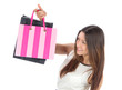 Young woman hold in hands shopping bags with presents