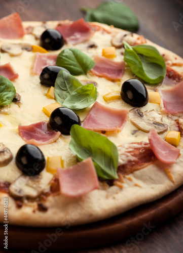 Photo: Pizza with mushrooms, ham and olives Pizza with mushrooms, ham and olives