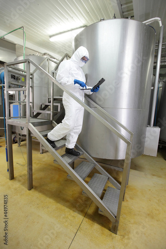Photo: scientist focused on tablet, walking down the stairs scientist focused on tablet, walking down the stairs